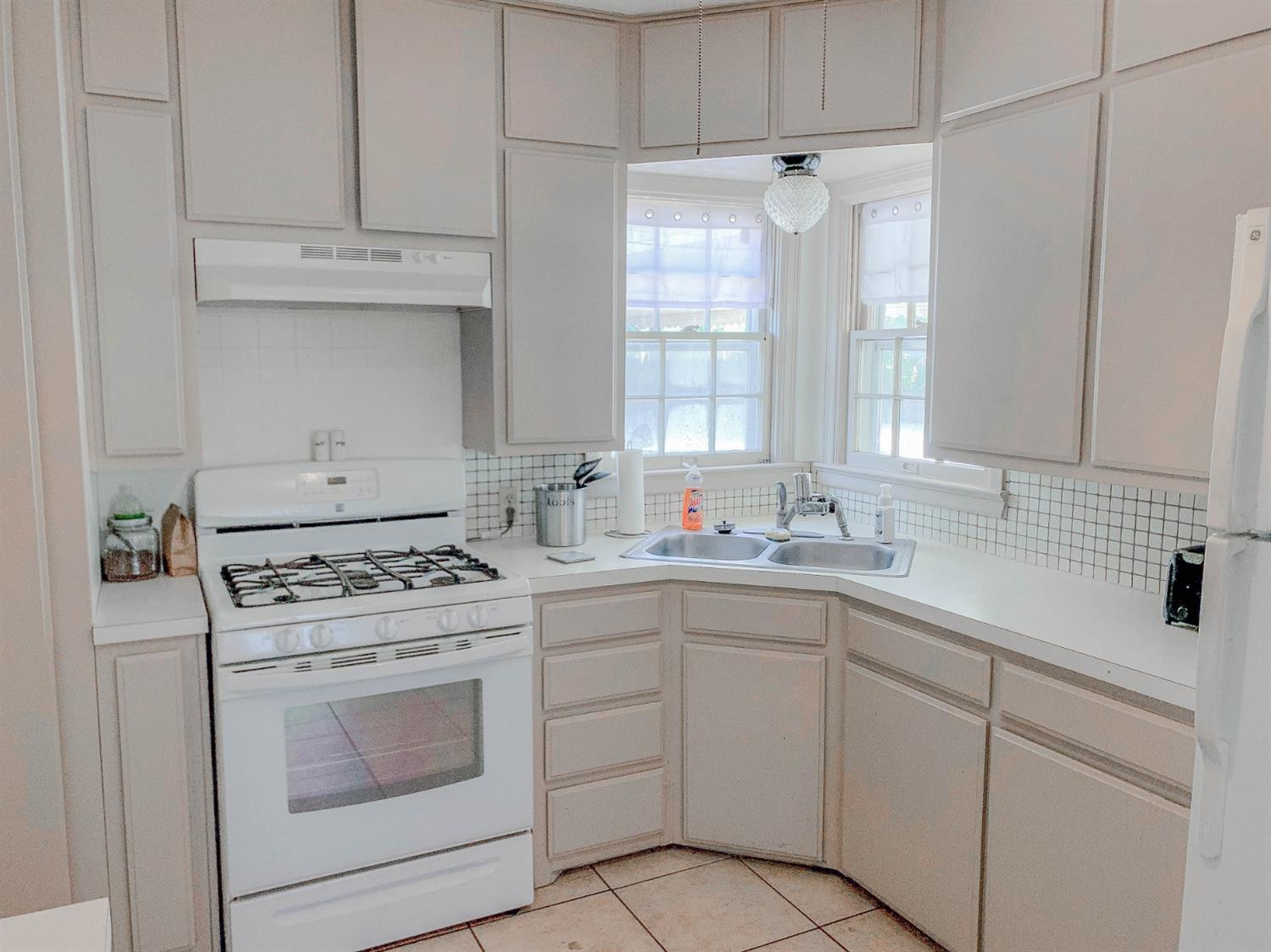 2401 26th Street Lubbock, TX 79411 - Photo 5 of 13 a kitchen with cabinets appliances a sink and a window