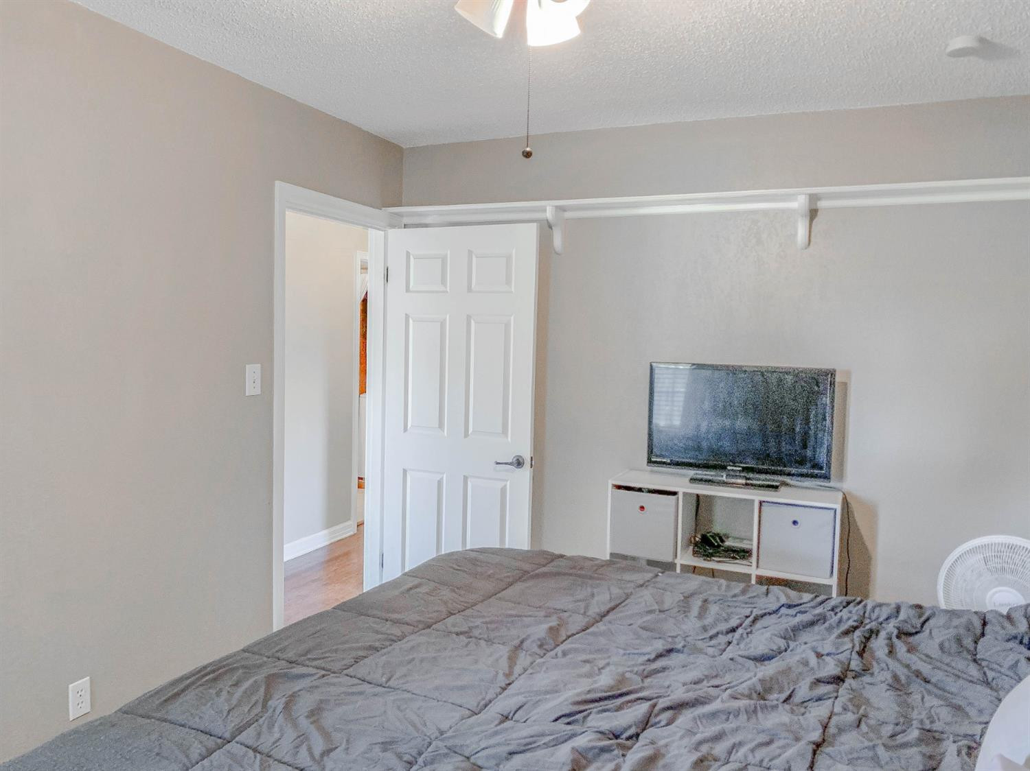 2401 26th Street Lubbock, TX 79411 - Photo 8 of 13 a bedroom with a bed and a flat screen tv