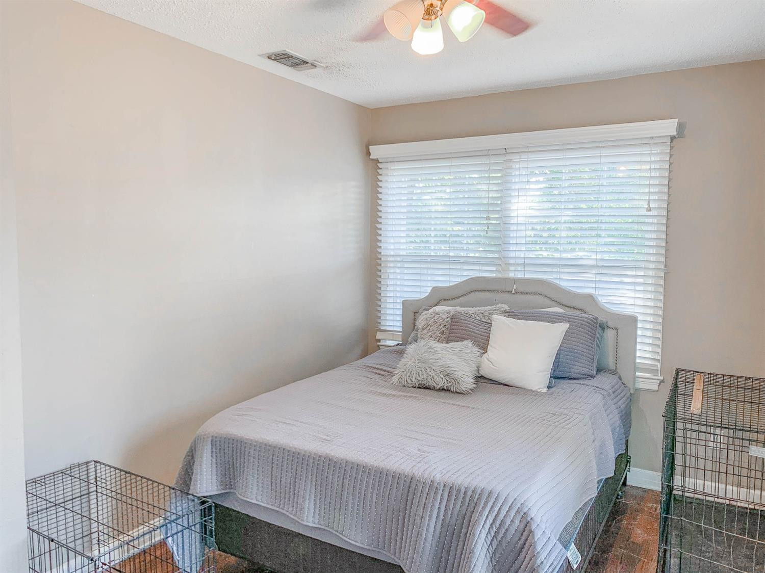 2401 26th Street Lubbock, TX 79411 - Photo 10 of 13 a bedroom with a bed and a chandelier