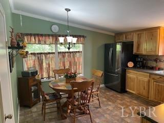 1065 Johnson Mountain Road Evington, VA 24550 - Photo 12 of 49 a kitchen with a refrigerator a sink dishwasher a dining table and chairs with wooden floor