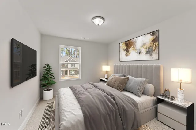 a bedroom with a large bed and a flat screen tv