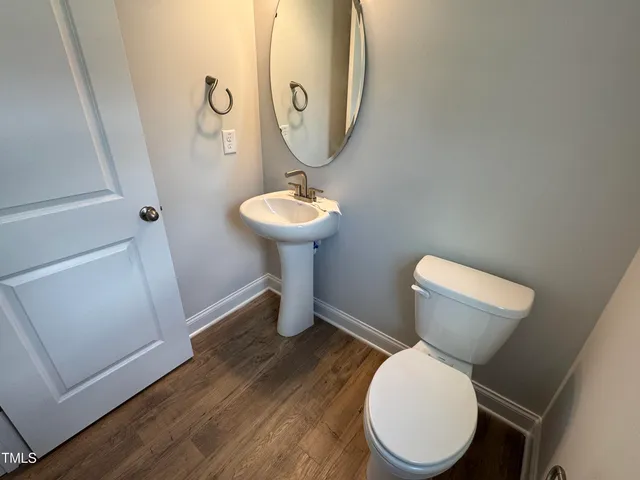 a white toilet sitting next to a bathroom sink