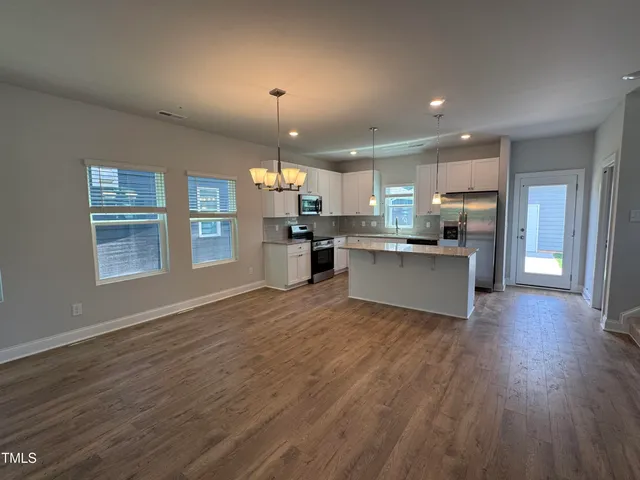 a view of kitchen with wooden floor and window