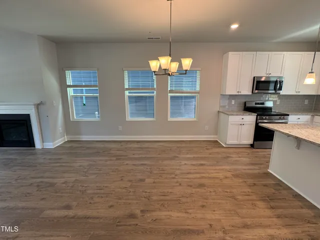 a view of a kitchen with a stove cabinets and wooden floor