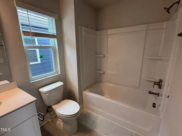 a bathroom with a toilet and a bathtub