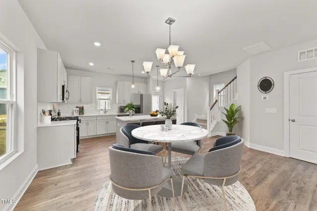 a view of a dining room with furniture and wooden floor
