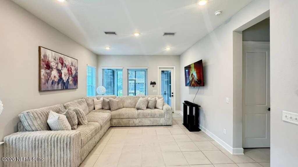 48 Bluebonnet Way St. Augustine, FL 32092 - Photo 11 of 46 a living room with furniture and a flat screen tv