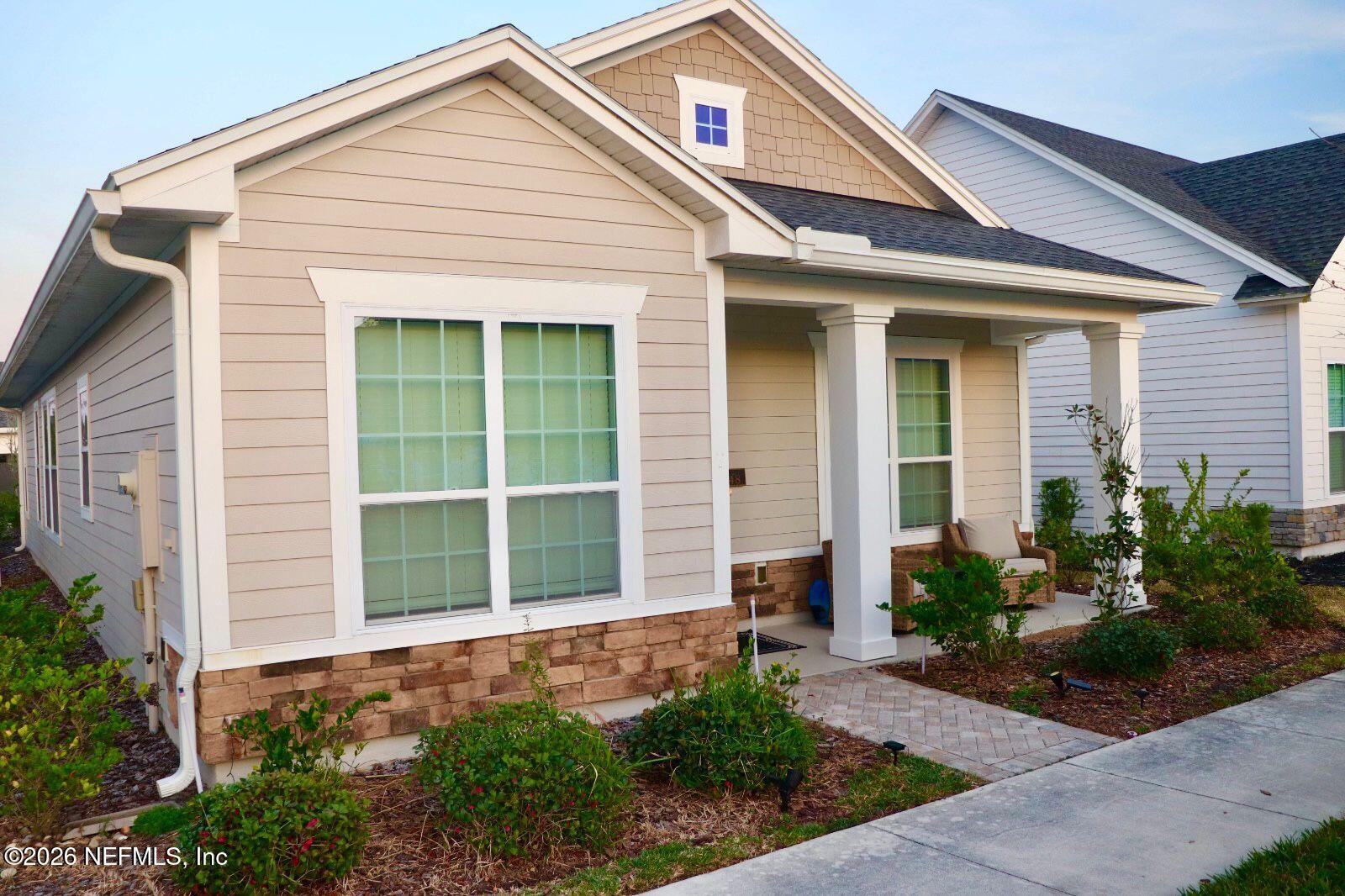 48 Bluebonnet Way St. Augustine, FL 32092 - Photo 2 of 46 a front view of a house with a yard and potted plants
