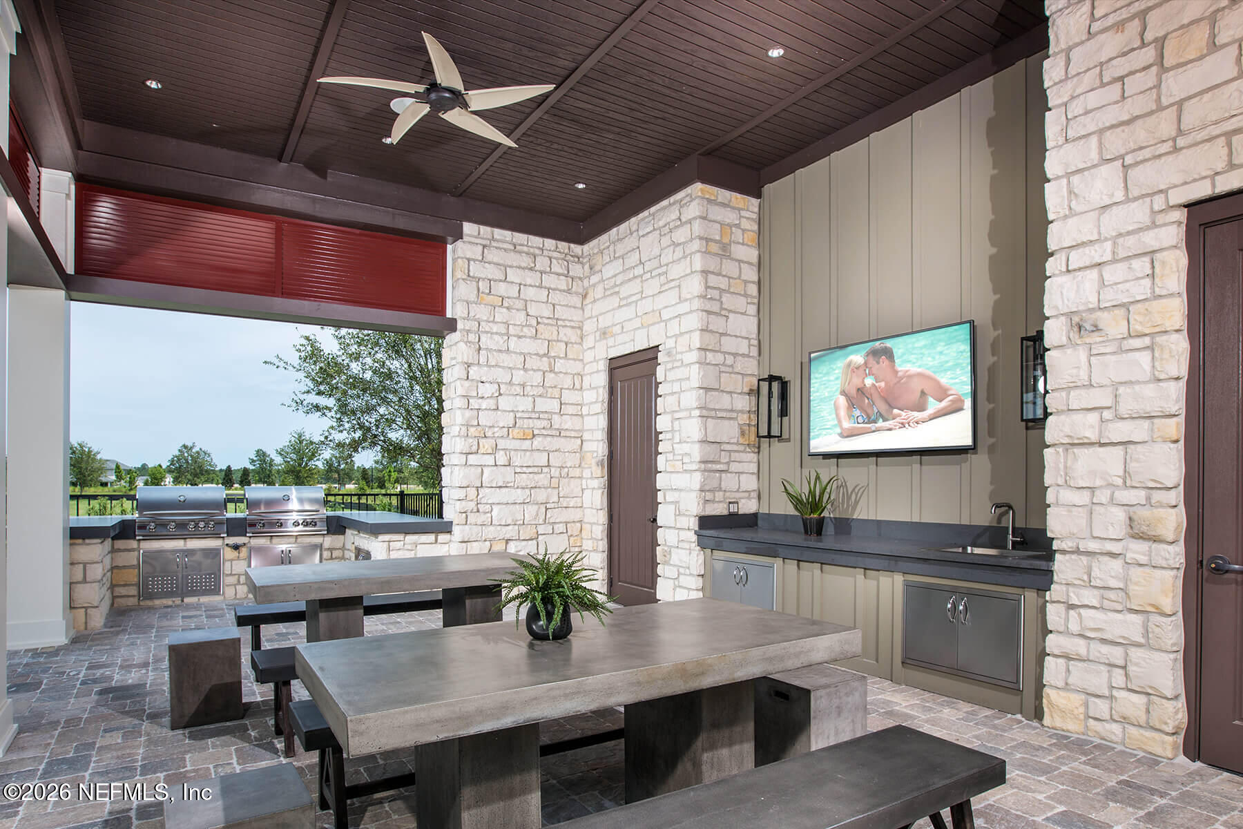 48 Bluebonnet Way St. Augustine, FL 32092 - Photo 40 of 46 a kitchen with stainless steel appliances kitchen island granite countertop a table chairs and a refrigerator
