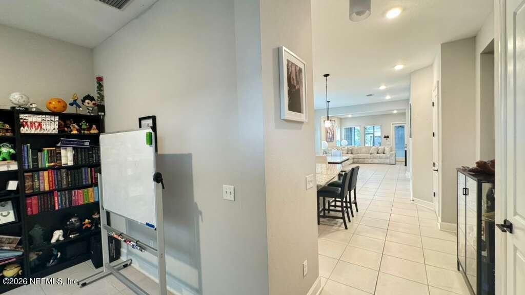 48 Bluebonnet Way St. Augustine, FL 32092 - Photo 4 of 46 a kitchen with stainless steel appliances kitchen island granite countertop a refrigerator and cabinets