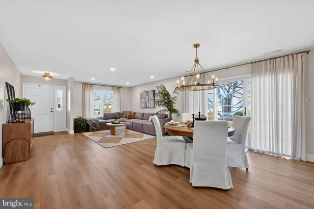 a living room with fireplace furniture and a wooden floor