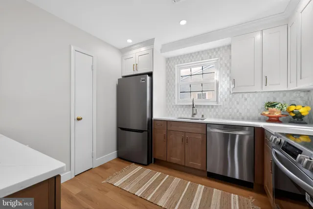a kitchen with stainless steel appliances granite countertop a refrigerator sink and stove