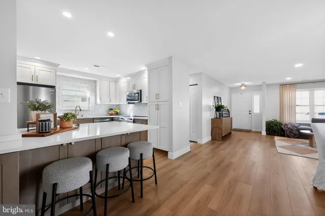 a large kitchen with a table and chairs