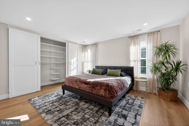 a bedroom with a large bed and a wooden floor