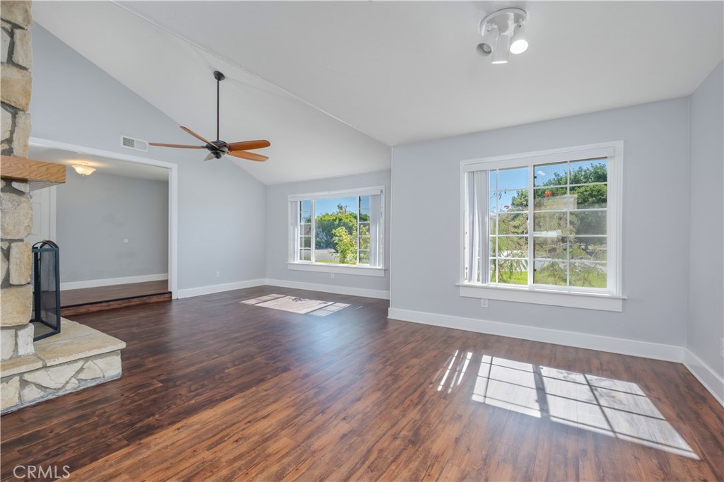 16810 Tava Lane Riverside, CA 92504 - Photo 11 of 33 a view of an empty room with a window and wooden floor