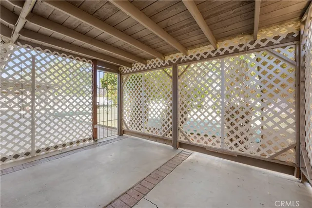 a view of a patio with table and chairs with wooden floor and fence