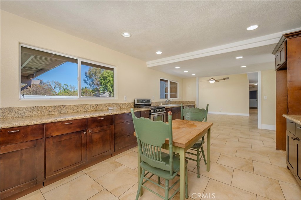 16810 Tava Lane Riverside, CA 92504 - Photo 5 of 33 a view of a kitchen with a dining table and chairs