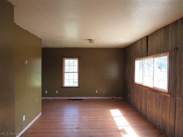 3845 Bower Road Rootstown, OH 44272 - Photo 6 of 20 Spare room with wooden walls and dark wood-type flooring