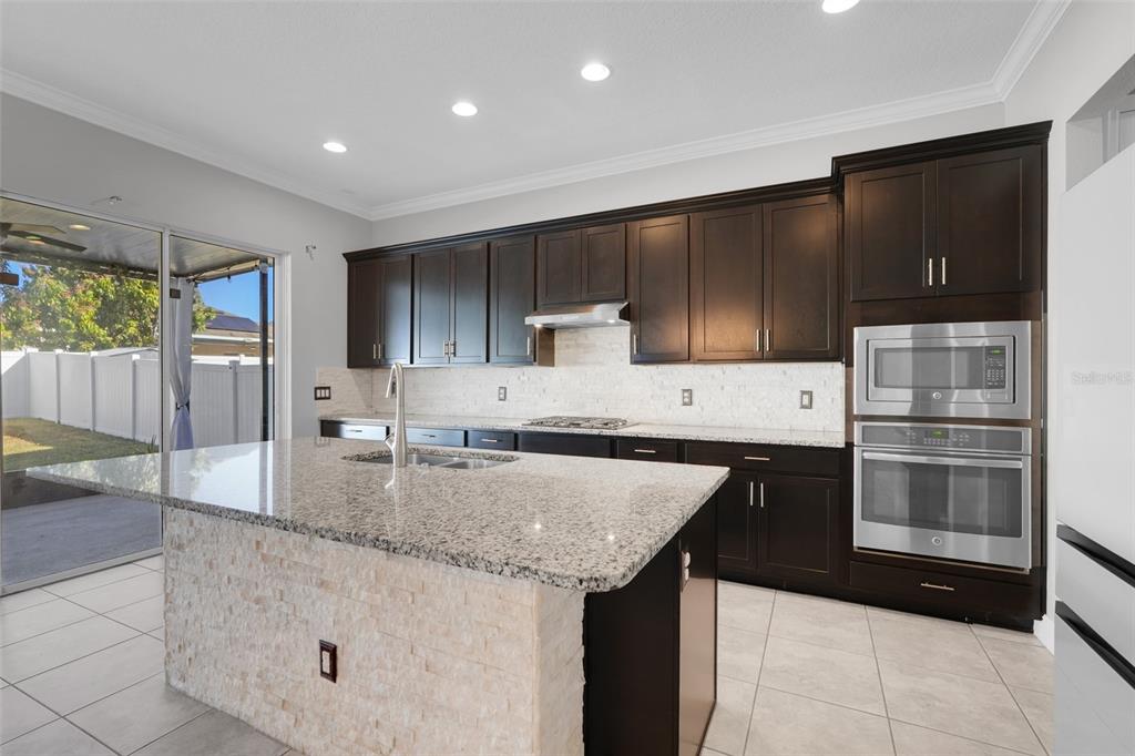 959 Maypole Drive Apopka, FL 32703 - Photo 14 of 44 a kitchen with granite countertop a sink and cabinets