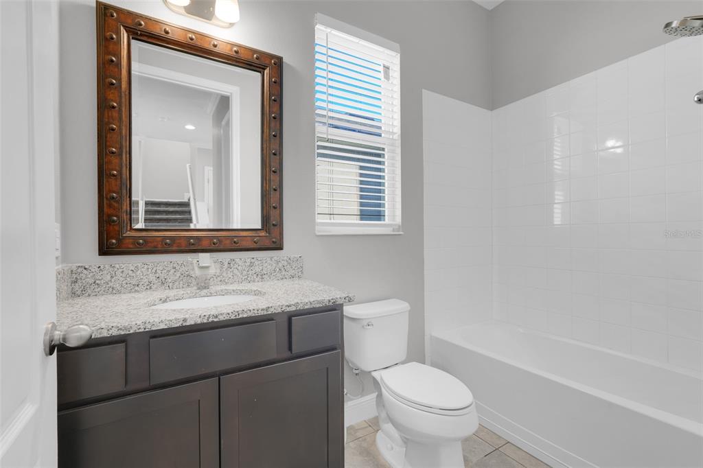 959 Maypole Drive Apopka, FL 32703 - Photo 19 of 44 a bathroom with a toilet sink and mirror