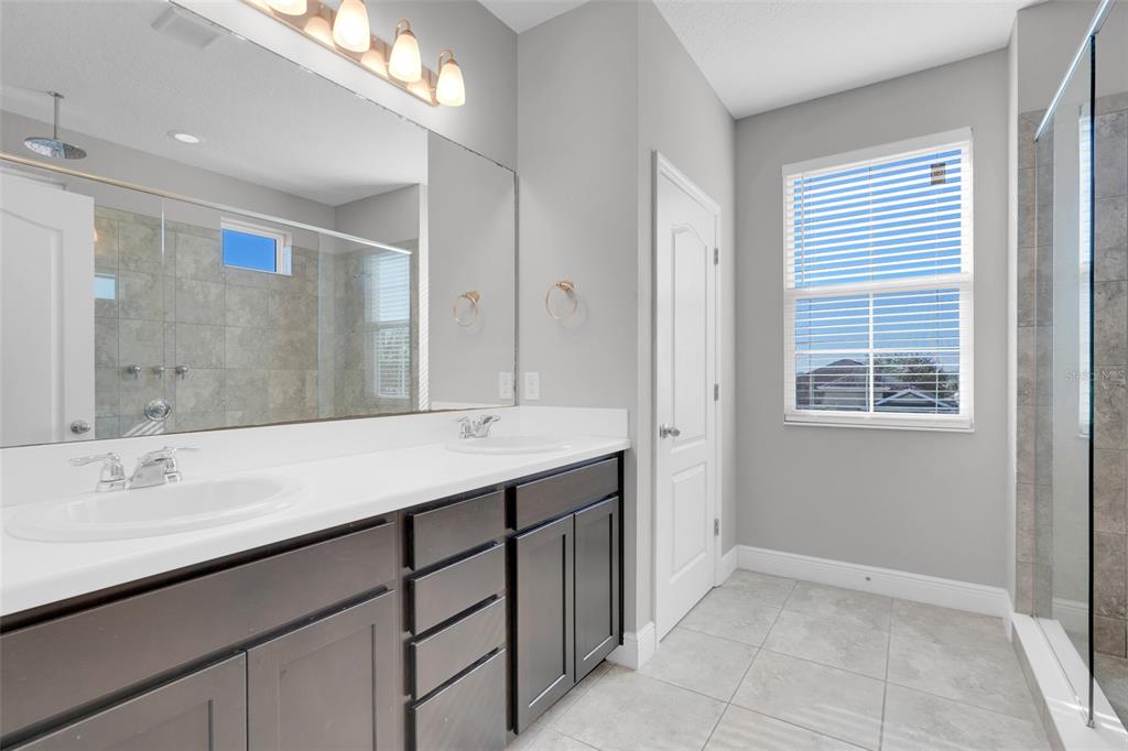 959 Maypole Drive Apopka, FL 32703 - Photo 26 of 44 a bathroom with a sink double vanity and a mirror