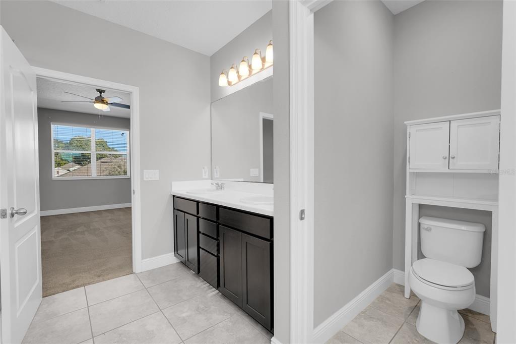 959 Maypole Drive Apopka, FL 32703 - Photo 27 of 44 a bathroom with a toilet a sink and mirror
