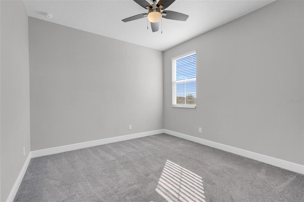 959 Maypole Drive Apopka, FL 32703 - Photo 32 of 44 an empty room with windows and fan