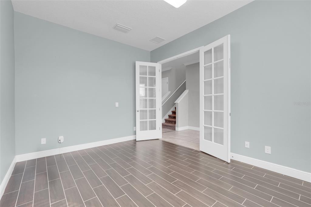 959 Maypole Drive Apopka, FL 32703 - Photo 4 of 44 an empty room with wooden floor and windows