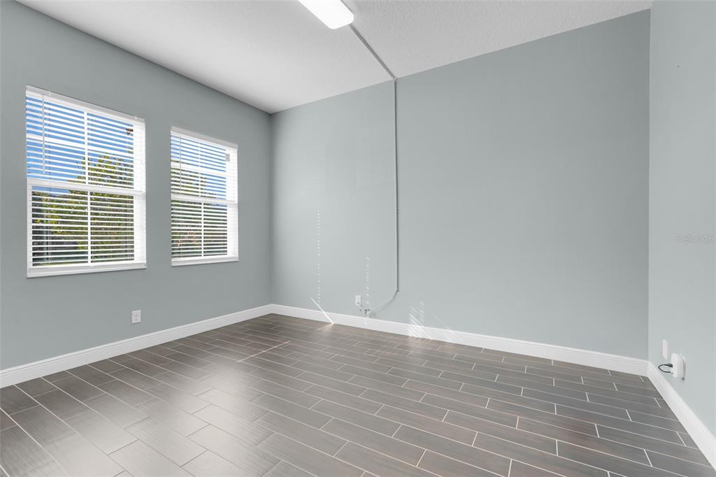 959 Maypole Drive Apopka, FL 32703 - Photo 5 of 44 a view of an empty room with wooden floor and a window