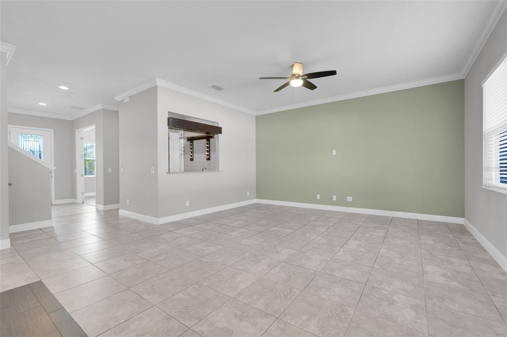 959 Maypole Drive Apopka, FL 32703 - Photo 9 of 44 an empty room with windows and fan