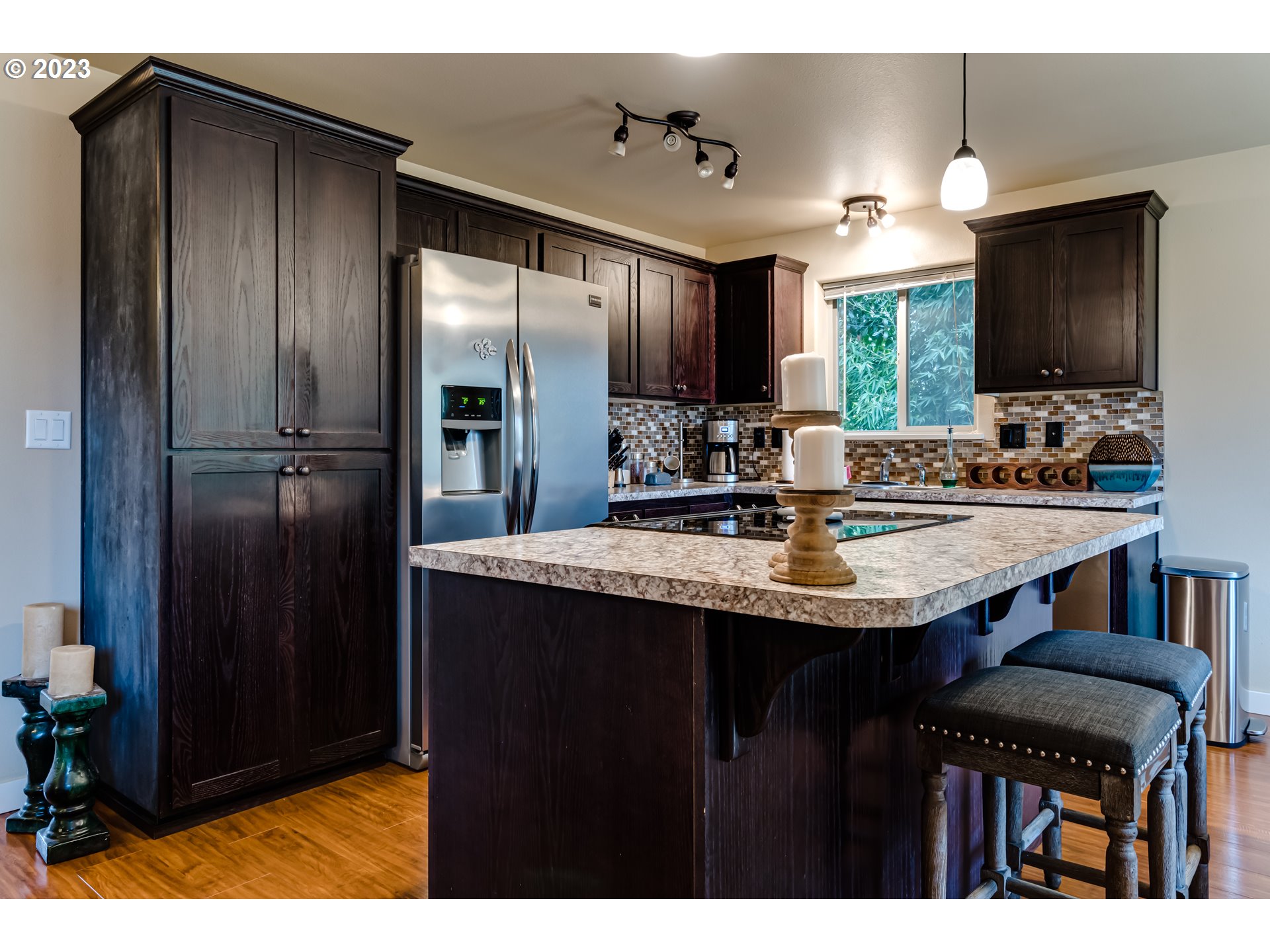 440 22nd Street Springfield, OR 97477 - Photo 7 of 31 a kitchen with kitchen island a sink stainless steel appliances and cabinets
