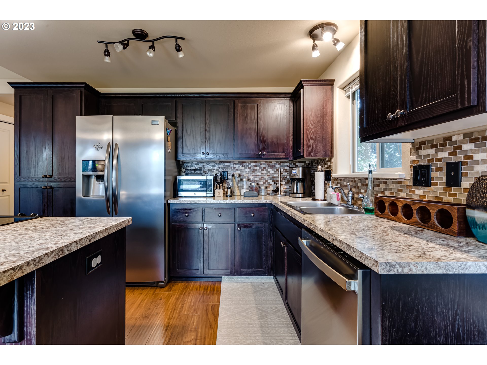 440 22nd Street Springfield, OR 97477 - Photo 9 of 31 a kitchen with stainless steel appliances granite countertop a sink a stove and refrigerator
