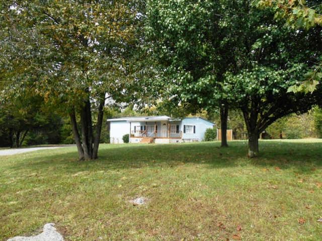 987 Hamilton Chambers Road Lebanon, TN 37087 - Photo 1 of 1 a view of a yard in front of a house with large trees