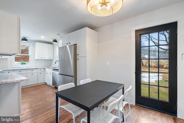 a kitchen with stainless steel appliances a stove a refrigerator and a microwave