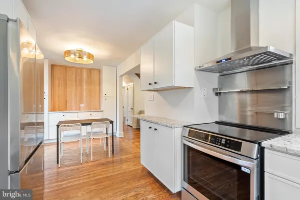 a kitchen with a stove and a refrigerator