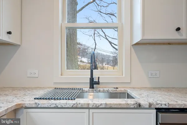 a kitchen with granite countertop a sink and a window