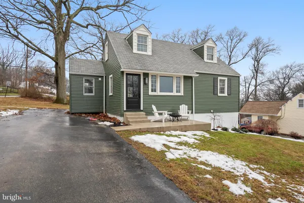a view of a house with a yard and tree s