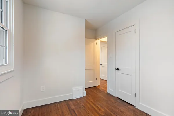 a view of a room with wooden floor and a window