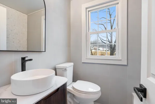 a white toilet sitting next to a bathroom sink