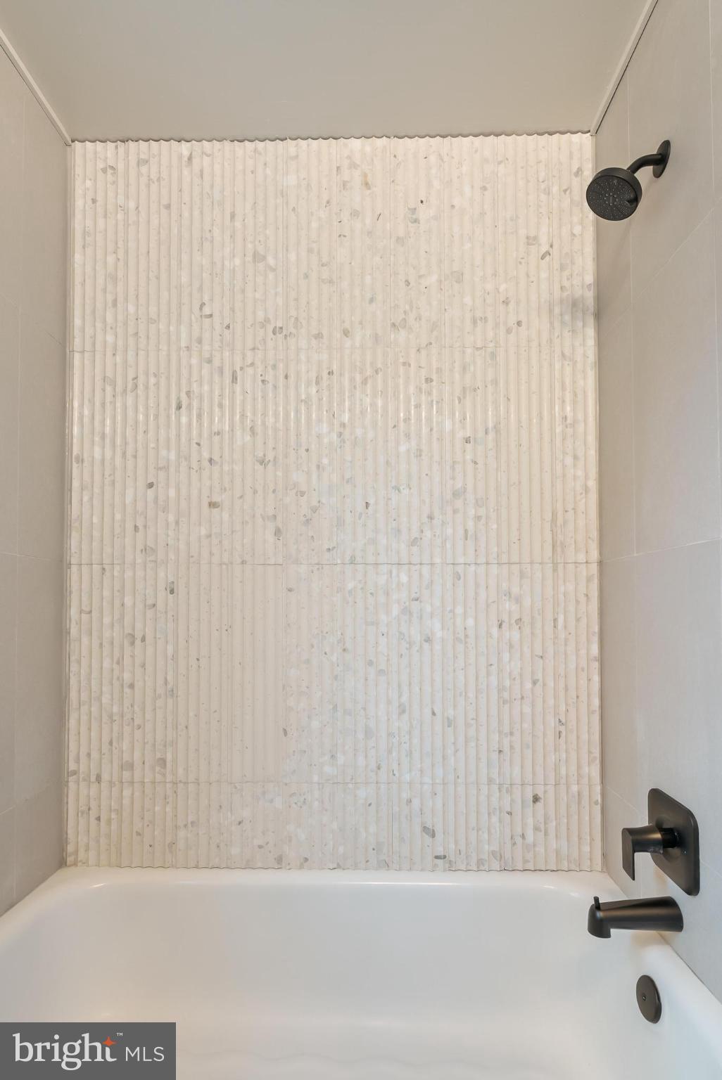 12 Longview Road Malvern, PA 19355 - Photo 25 of 44 Sleek marble shower with modern fixtures.