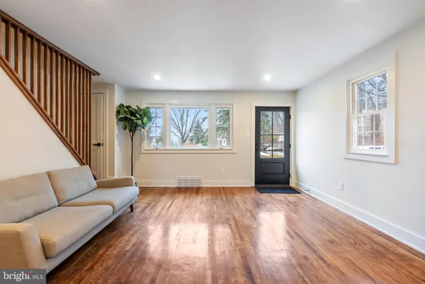 a view of livingroom with furniture wooden floor and windows