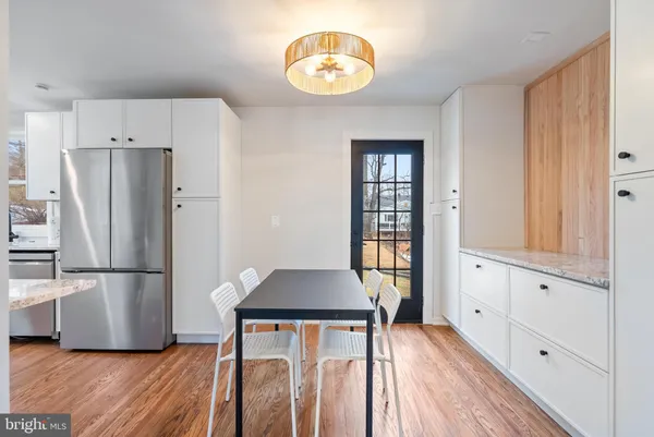 a kitchen with stainless steel appliances granite countertop a refrigerator and a stove top oven