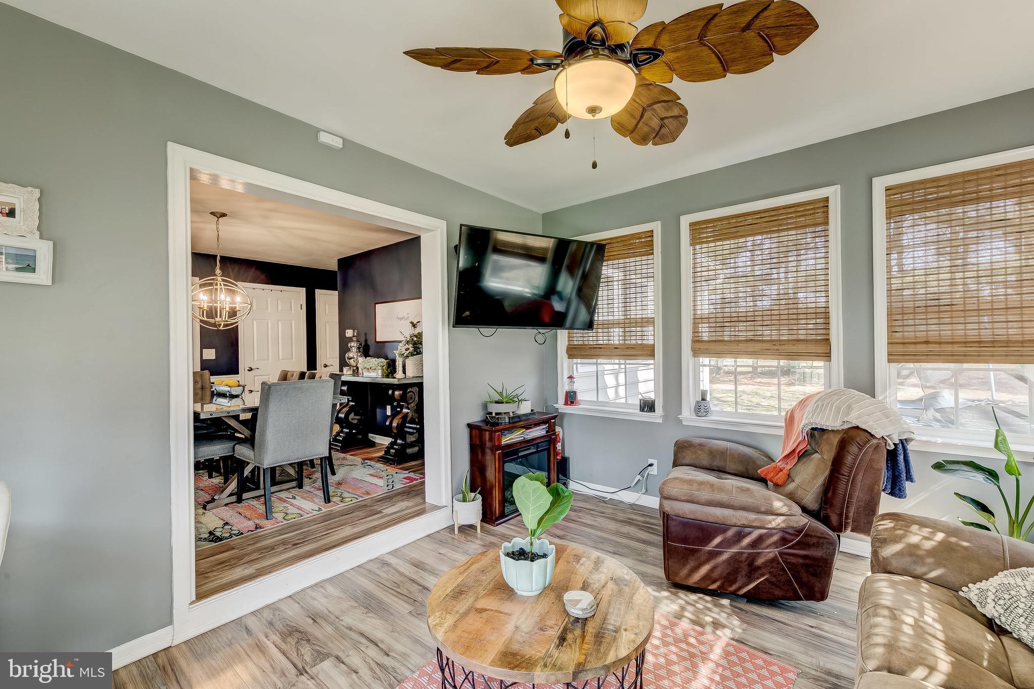 31275 East Line Road Delmar, MD 21875 - Photo 16 of 41 a living room with patio furniture large windows and wooden floor