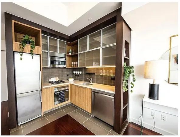 a kitchen with stainless steel appliances granite countertop a refrigerator a stove and a sink with wooden floor