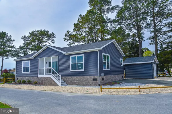 a house that has a tree in front of it