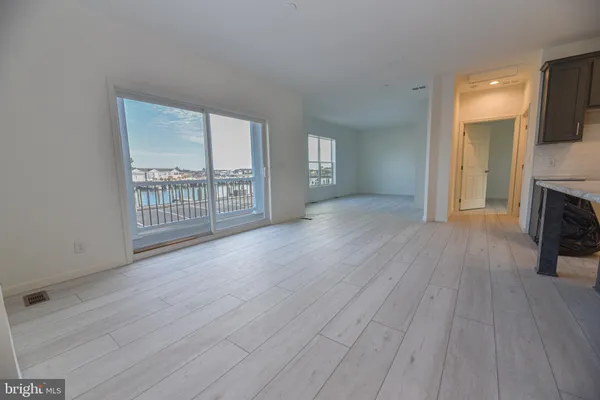 an empty room with wooden floor and fireplace