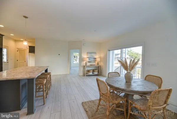 a dining room with furniture and wooden floor