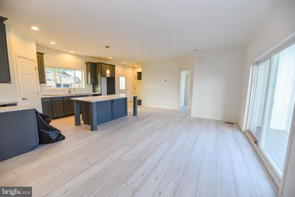 a view of kitchen with cabinets and wooden floor