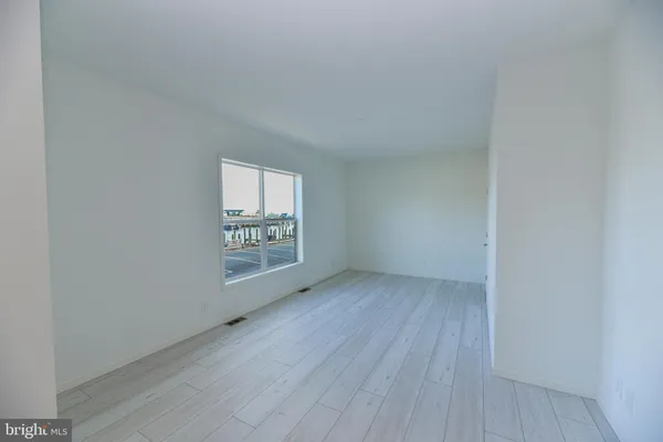 a living room with furniture a rug and a window