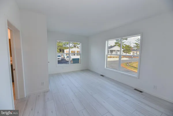 a bedroom with a large bed and wooden floor